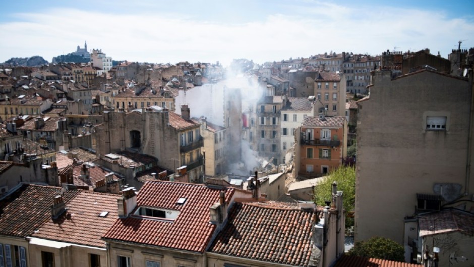 The rescuers' task has been complicated by the partial collapse of one of the adjoining buildings