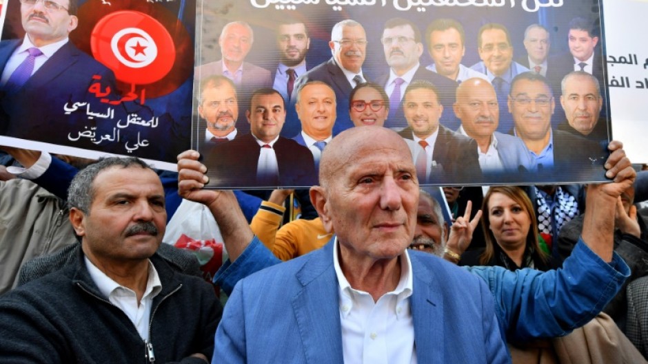 Tunisian demonstrators including Ahmed Nejib Chebbi, president of the National Salvation Front coalition, held signs with images of the detainees