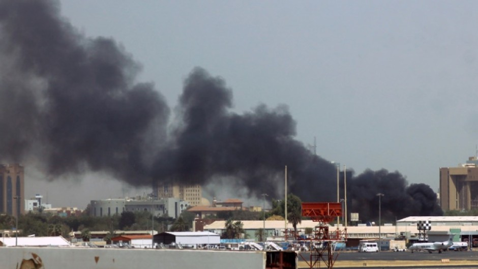 Smoke billows out from near Khartoum's airport on April 15, amid clashes in the Sudanese capital in which  Saudia said one of its aircraft was hit by gunfire