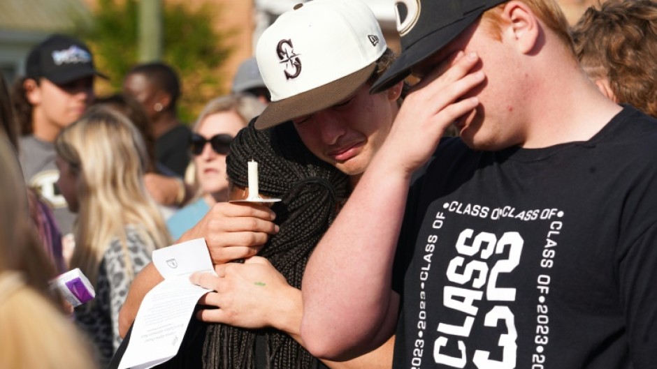 Mourners attend a vigil outside a church in Dadeville, Alabama on April 16, 2023, the day after a mass shooting at a teen's birthday party left four people dead and 28 others injured