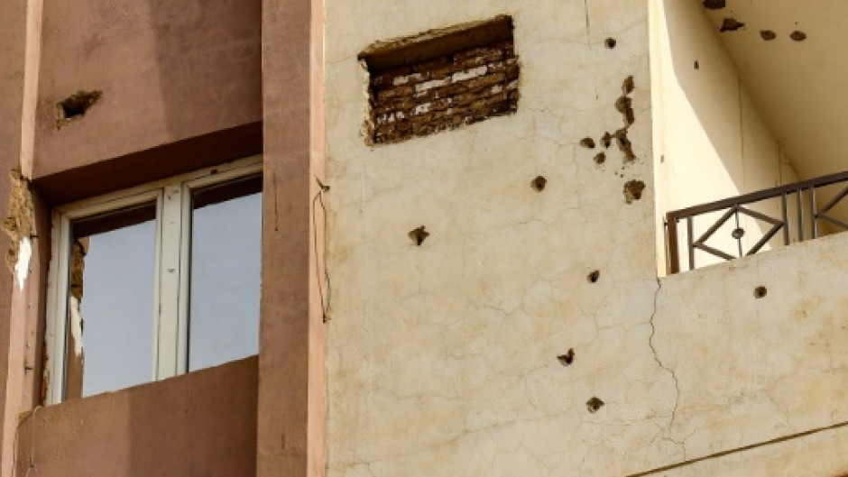 Bullet holes riddle the facade of a building in Khartoum 