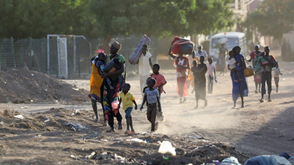 People flee their neighbourhoods amid fighting between the army and paramilitaries in Khartoum