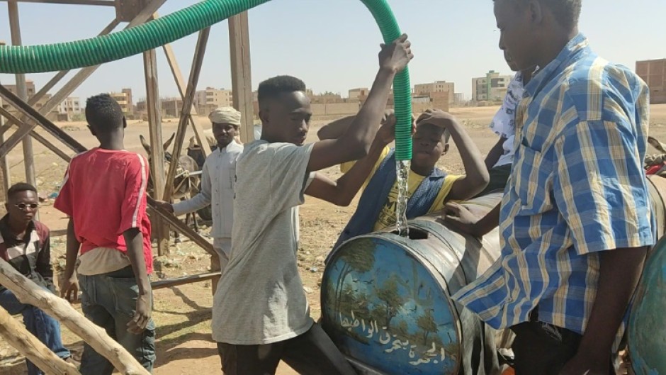 Sudanese collect water amid shortages caused by fighting