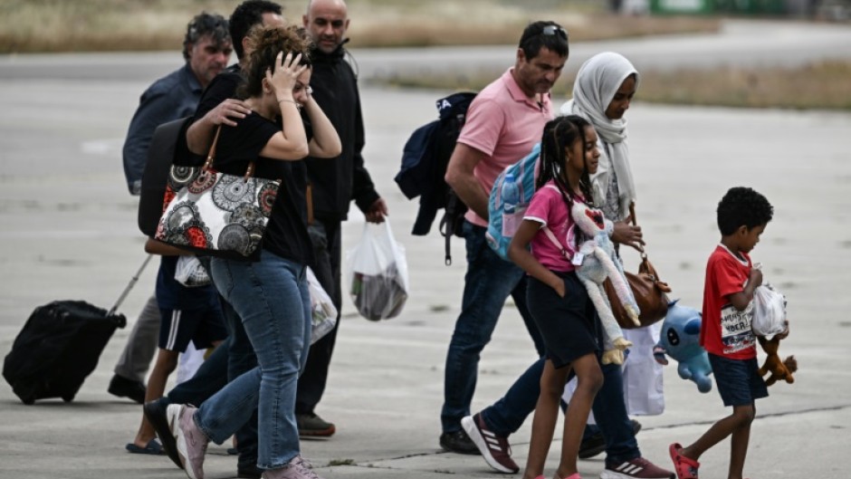 Greek nationals from Sudan arrive with a military C-27 plane at the military airport of Elefsina, south of Athens