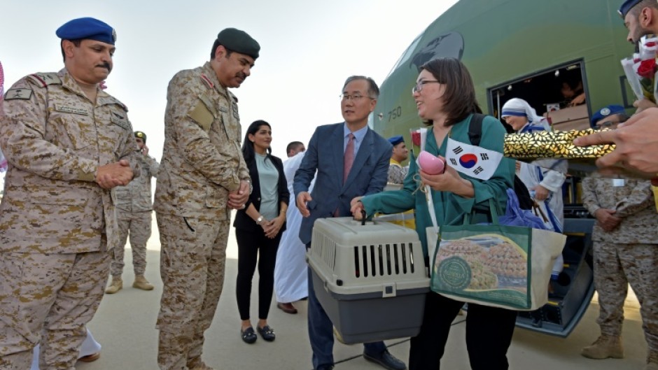 South Korean diplomats who fled the violence in Sudan disembark from a military plane in Jeddah, Saudi Arabia