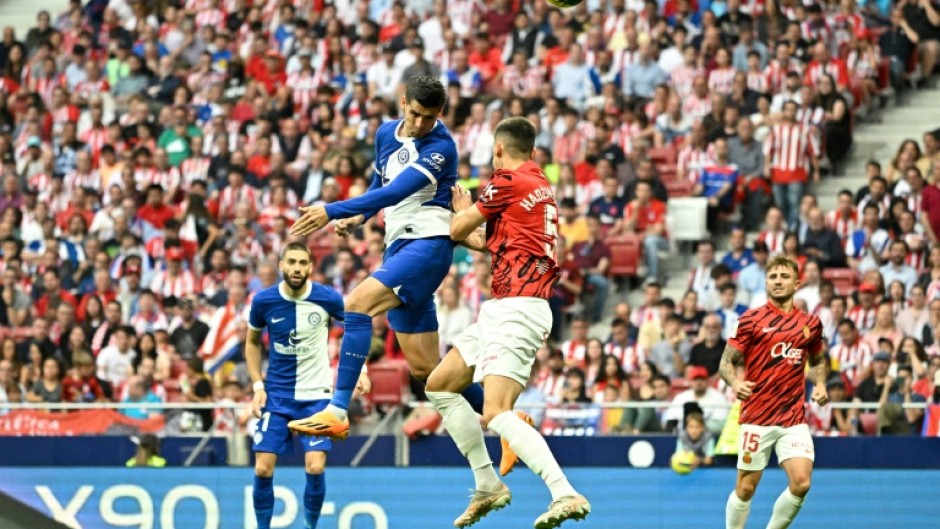 Atletico Madrid's Spanish forward Alvaro Morata (C) heads the ball home for his side's second against Mallorca