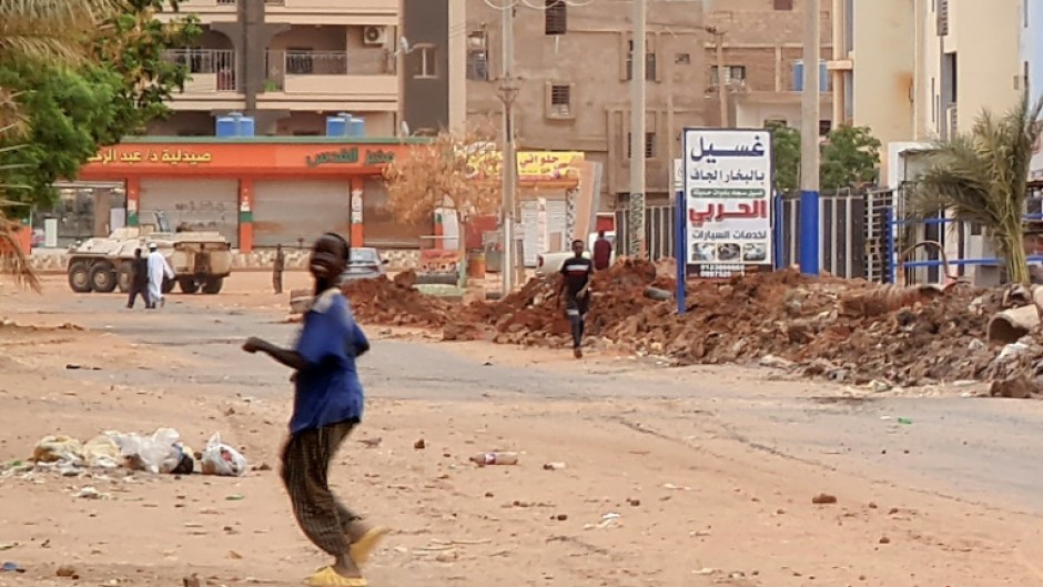 Foreigners fleeing Sudan disembark from a Saudi evacuation ship after it docks in the Red Sea port of Sudan