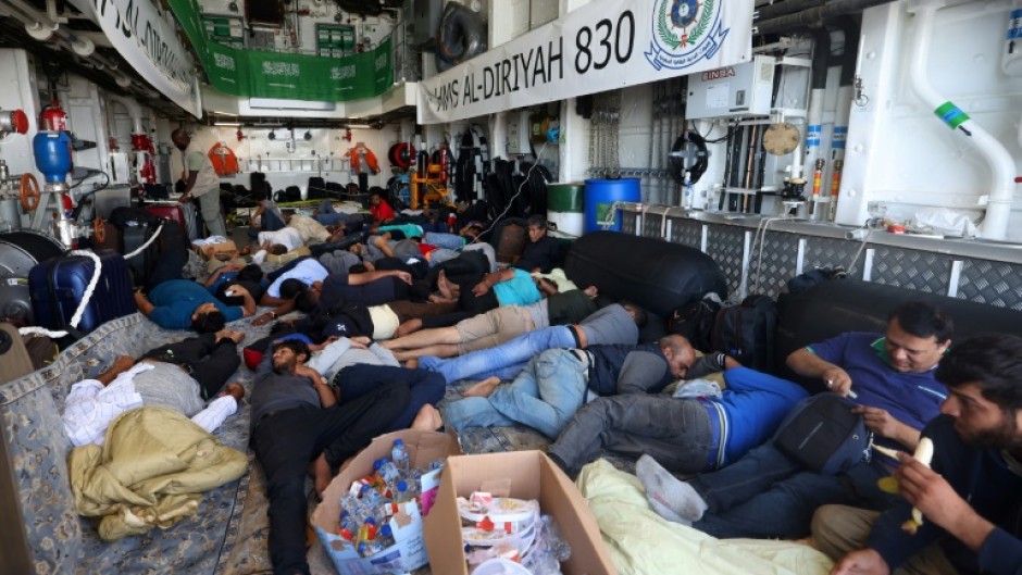 Evacuees rest on the Saudi Arabian warship HMS Al-Diriyah, transporting them from Port Sudan to Jeddah