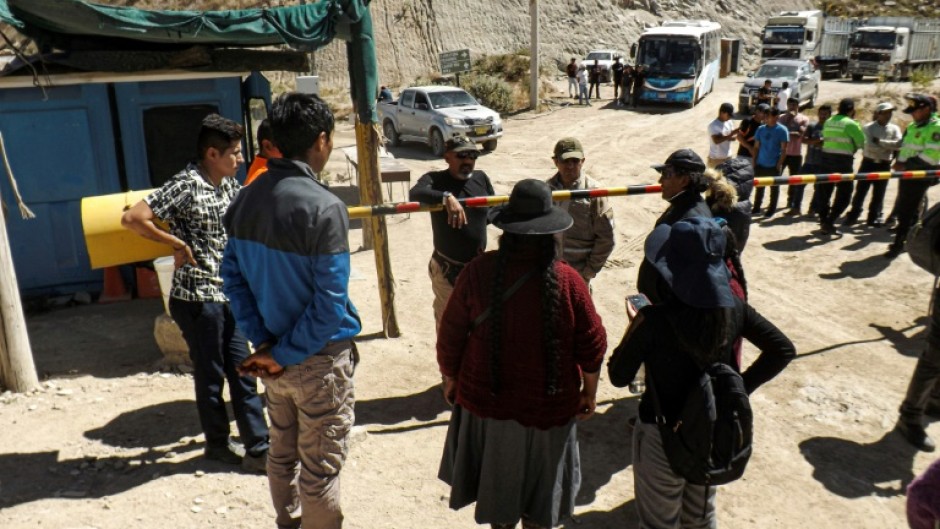 Relatives of miners wait for information at the entrance of the La Esperanza mine, where at least 27 people died following a fire