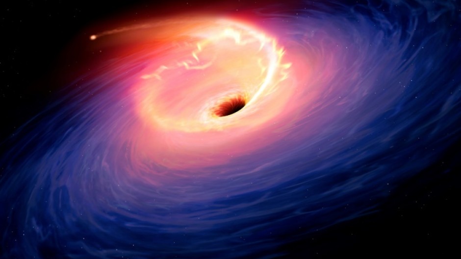 An artist's illustration of a star being sucked into a black hole -- just one theory for what caused the largest explosion astronomers have observed