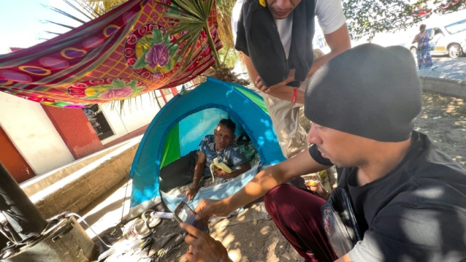 Even finding a place to charge a cell phone is a challenge for many migrants