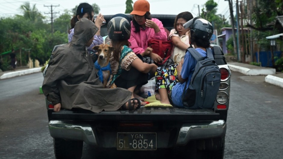 People evacuate in Sittwe in Myanmar's Rakhine state on May 13, 2023, ahead of the expected landfall of Cyclone Mocha on May 14