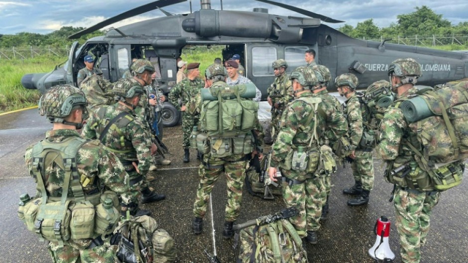 Soldiers board a helicopter to search for the lost children, in this handout photo from the Colombian armed forces