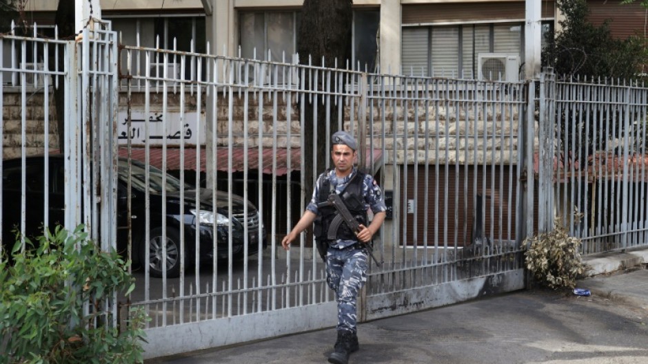 An officer stands guard outside the Justice Palace where Lebanese central bank chief Riad Salameh appeared