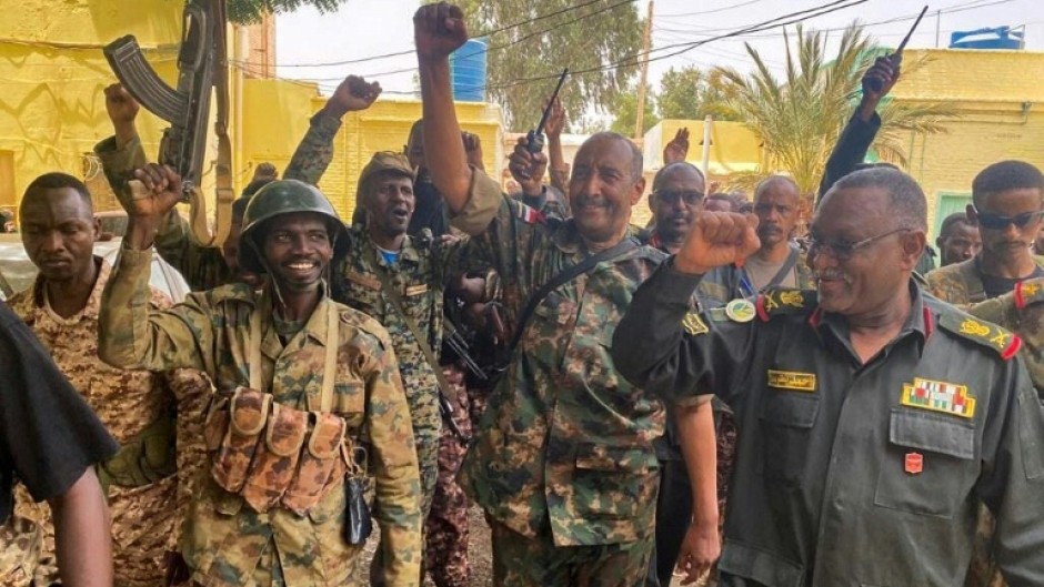 Sudan's army chief Abdel Fattah al-Burhan cheering with soldiers as he visits some of their positions in Khartoum