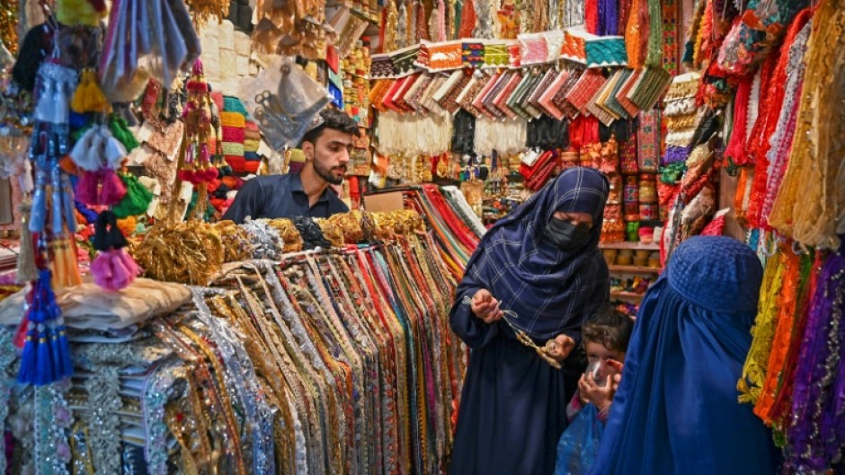 Women shop for jewellery at a market in Peshawar on June 8, a day before Pakistan releases its budget