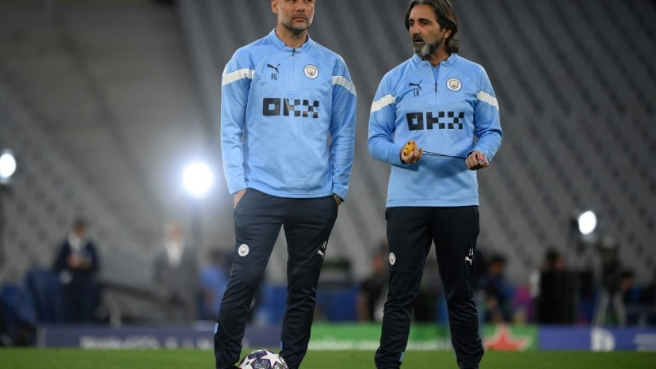 Pep Guardiola (L) alongside Manchester City's Spanish fitness coach Lorenzo Buenaventura as their team train at the Ataturk Olympic Stadium in Istanbul on Friday