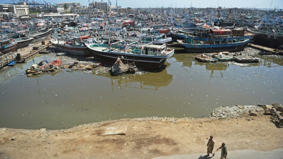 Fishing boats are anchored at a harbour in Karachi, where some people will be evacuated ahead of a cyclone this week