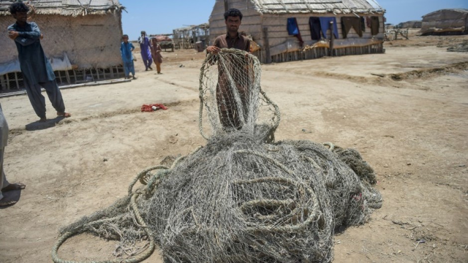 Villagers wait to be evacuated to government relief camps before the arrival of the cyclone,  in Sujawal district, Sindh province