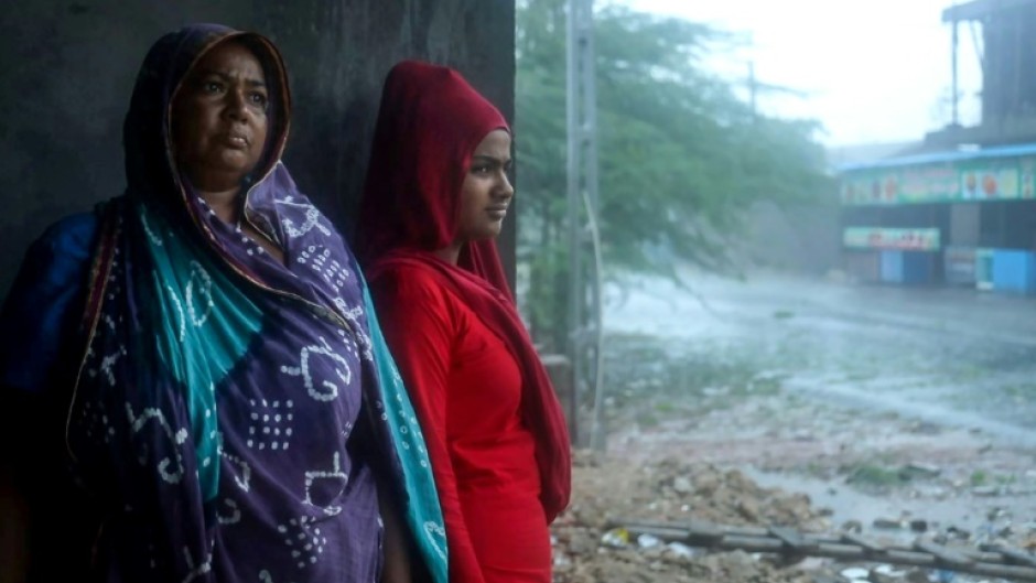 Cyclone Biparjoy tore down power poles and uprooted trees after pummelling the Indian coastline, though the storm was weaker than feared 