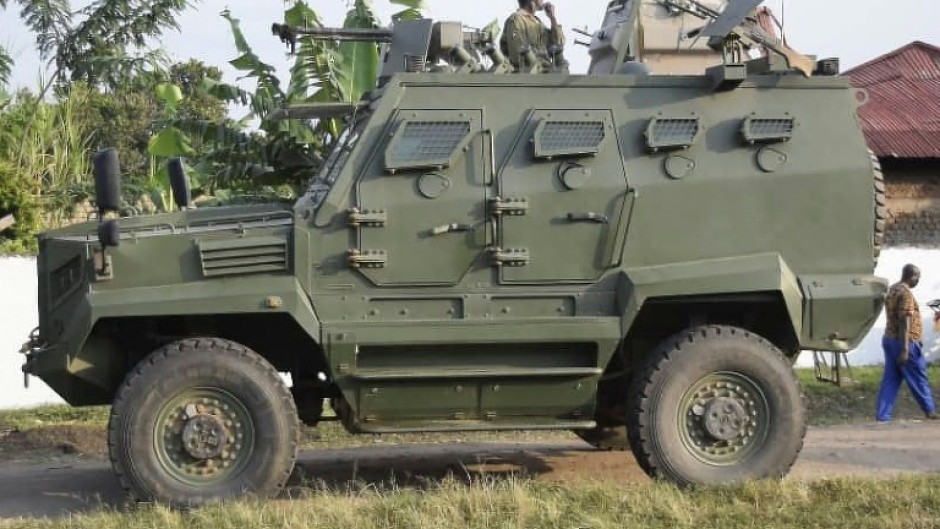 A Uganda People's Defence Force (UPDF) armoured personnel carrier stands guard outside the school in Mpondwe