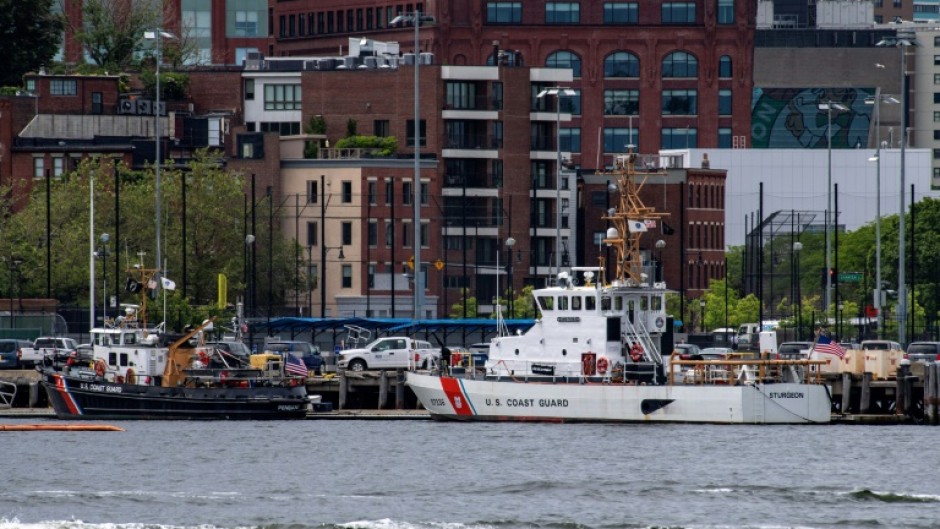 Two US Coast Guard vessels sit in port in Boston Harbor, from where authorities are mounting a search for a submersible that went missing during an expedition to the wreckage of the Titanic in the North Atlantic