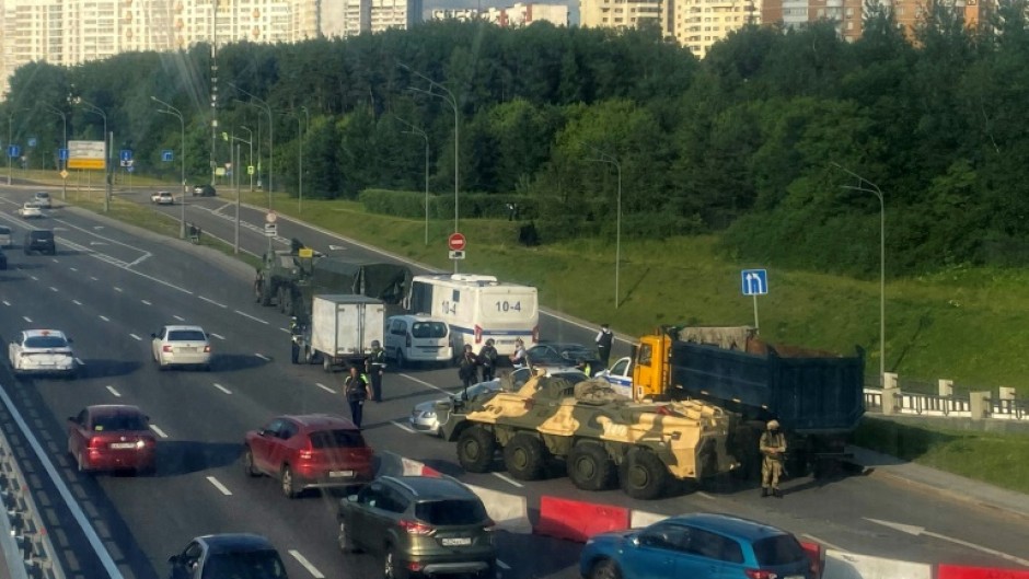 Russian police officers and servicemen block part of a highway entering Moscow on June 24, 2023