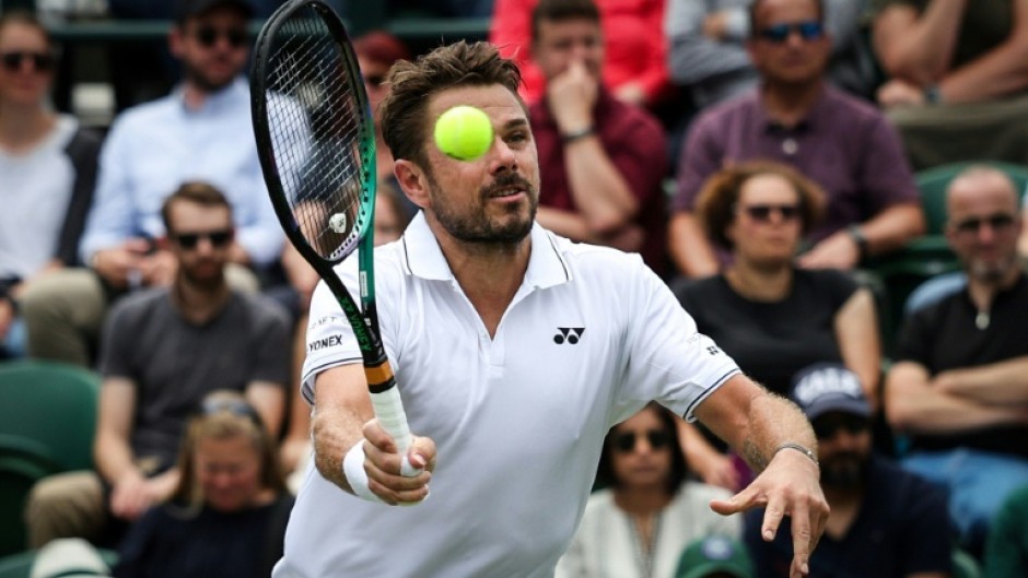 Senior service: Stan Wawrinka returns the ball to Argentina's Tomas Martin Etcheverry 