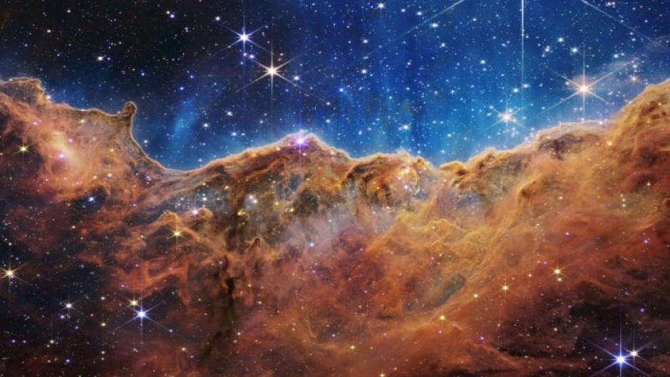 The so-called Cosmic Cliffs of a star-forming region in a part of space called the Carina Nebula, one of the James Webb Space Telescope's first released images