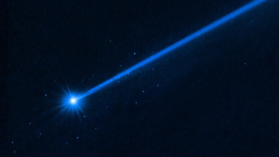 The small spots of light around the asteroid Dimorphos are boulders sent off by the impact of the NASA probe, a Hubble telescope image shows