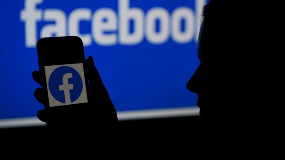 File: Facebook page on a computer and app. AFP/Olivier Douliery