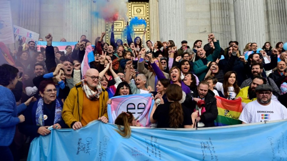 Spanish activists celebrate a vote in favour of the country's transgender rights bill