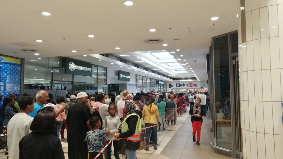 People queue in Cape Town to get their final shopping in before the 21-day lockdown.