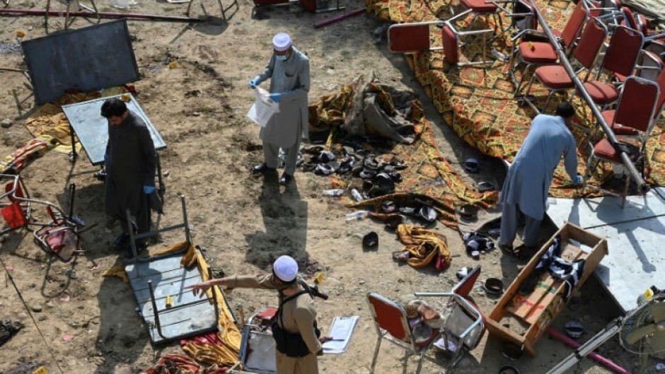 Investigators examine the site of Sunday's suicide bomb blast