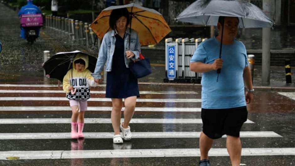 Hundreds of millions of people in northern China, including Beijing, remain under a red alert for heavy rain