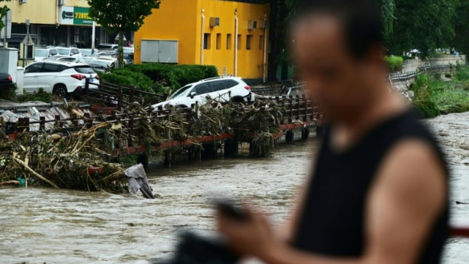 At least 11 people are known dead after heavy rains wreaked havoc in Beijing, state media has said