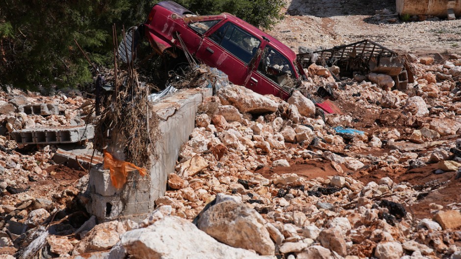  A car is buried in rubble and debris in the aftermath of a devastating flood in al-Bayda town in eastern Libya. AFP