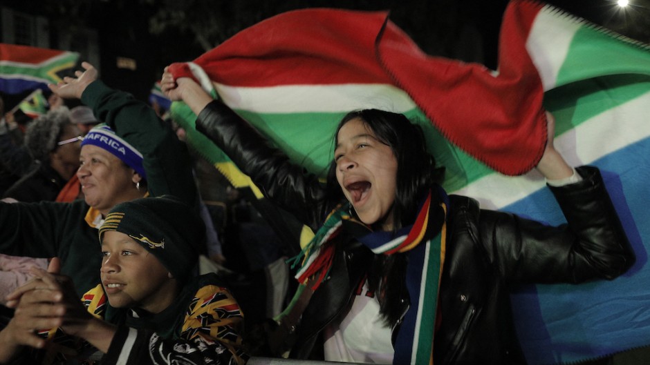 South African rugby supporters celebrate at the Bree Street fan park in Cape Town. AFP/Gianluigi Guercia