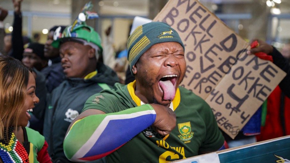 A supporter reacts ahead of the South African rugby team's arrival at the OR Tambo International airport in Ekurhuleni on October 31, 2023, after they won the France 2023 Rugby World Cup final match against New Zealand.