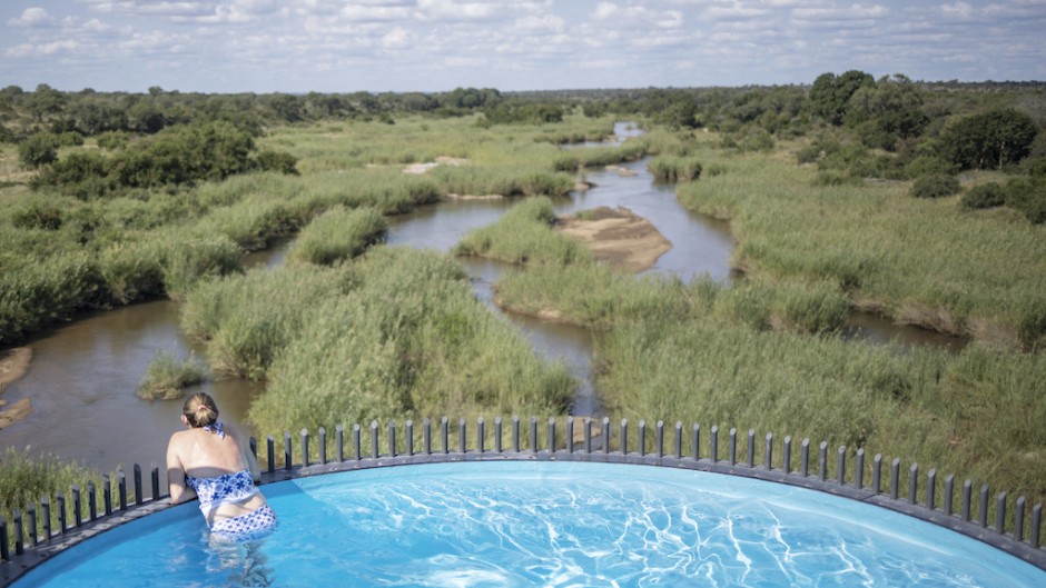 File: A guest overlooks the landscape from a suspended pool at the Kruger Shalati hotel in Skukuza. AFP/Michele Spatari