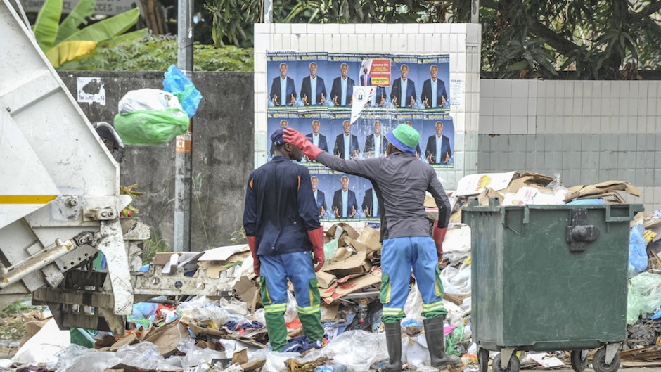 File: Workers prepare to load garbage into a truck. AFP