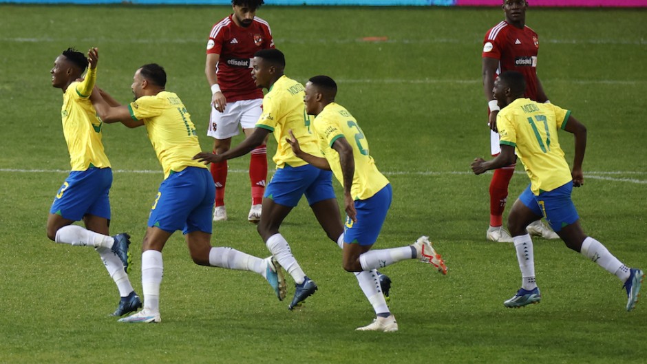 Sundown's midfielder Thapelo Maseko celebrates with teammates after scoring a goal. AFP/Phill Magakoe