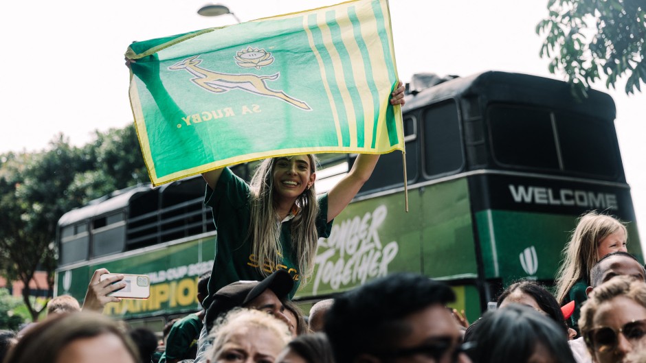 A springbok supporter hold up a flag during the Springboks Champions trophy tour in Durban, on November 4, 2023, after South Africa won the France 2023 Rugby World Cup final match against New Zealand. (Photo by RAJESH JANTILAL / AFP)