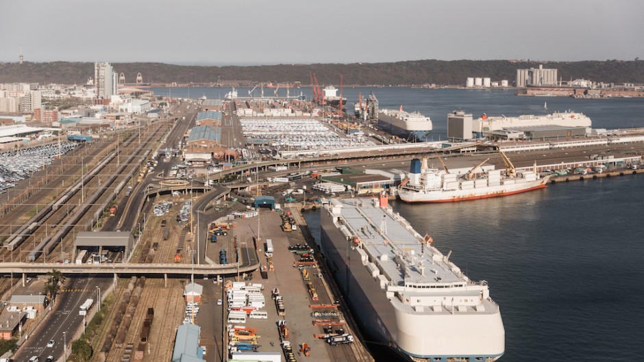 Cargo vessels and trucks are seen at the Port of Durban harbour. AFP/Rajesh Jantilal