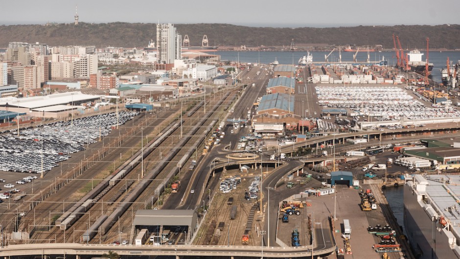 Trucks and cargo vessels are seen at the Port of Durban harbour. AFP/Rajesh Jantilal