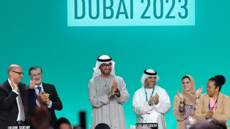 COP28 president Sultan Ahmed Al Jaber (C) applauds among other officials before a plenary session during the United Nations climate summit in Dubai. AFP/Giuseppe Cacace