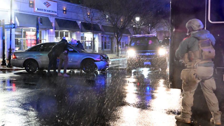 Members of the US Secret Service rush to a car after it hit a motorcade SUV as US president Joe Biden was leaving his campaign headquarters in Wilmington. AFP/Andrew Caballero-Reynolds