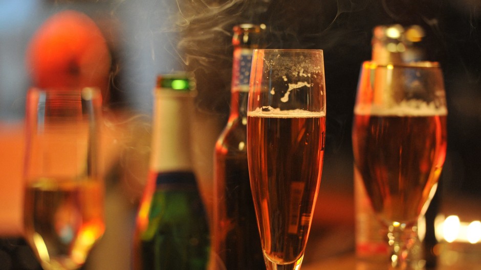 File: Glasses with Alcohol are standing on the counter of a bar.