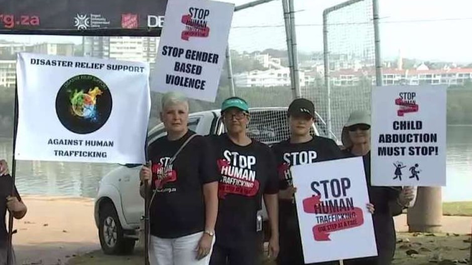 Protesters with signs against human trafficking.