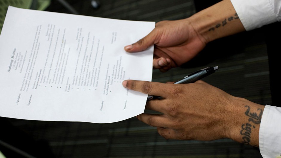 File: A job seeker holds his CV before and interview. Brooks Kraft LLC/Corbis via Getty Images